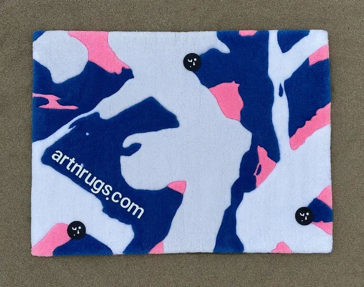 Front view of the blue, cream and pink rug on grey carpet.