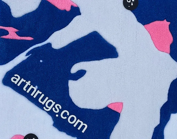 close-up of hand-tufted wool texture on blue white pink abstract rug by Ksenia Derr