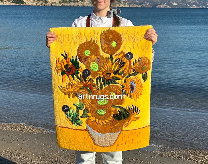 Person holding the Sunflowers wall rug with the sea behind.