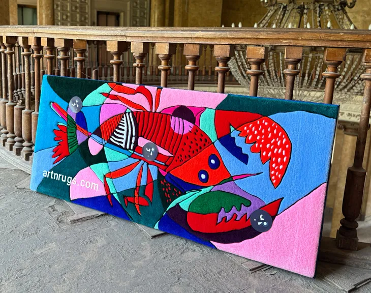 Kseniia Derr presenting the abstract lobster wall hanging.