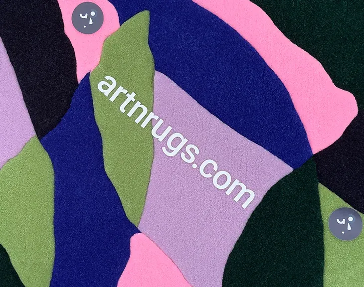 Close-up of pink, green and blue yarn in the leaf rug.