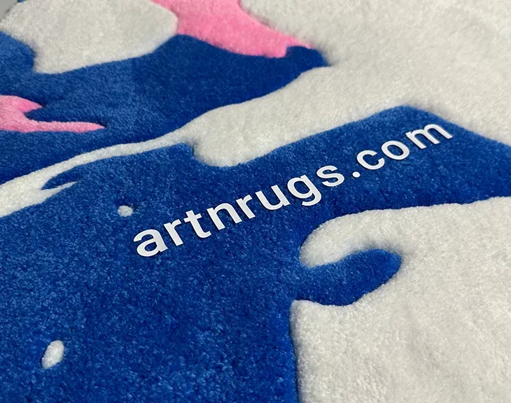 branding detail: artnrugs.com logo on Ksenia Derr's blue white pink abstract hand-tufted rug