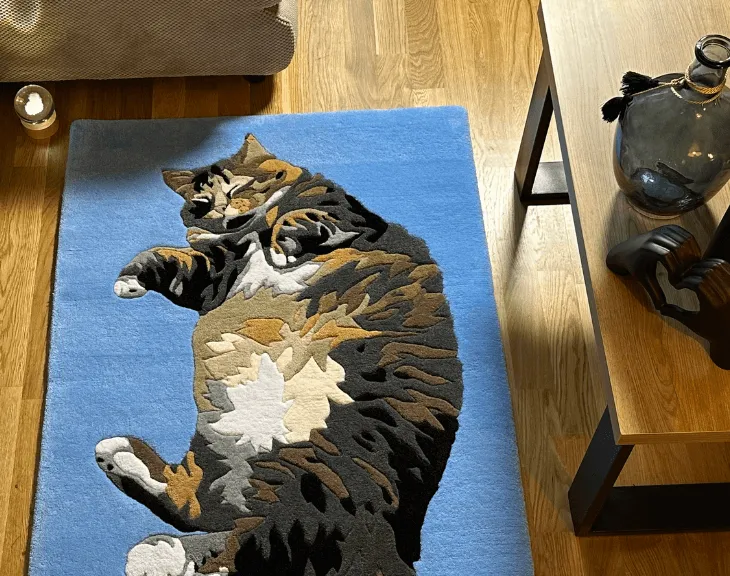 Full-body cat portrait rug displayed in a living room.