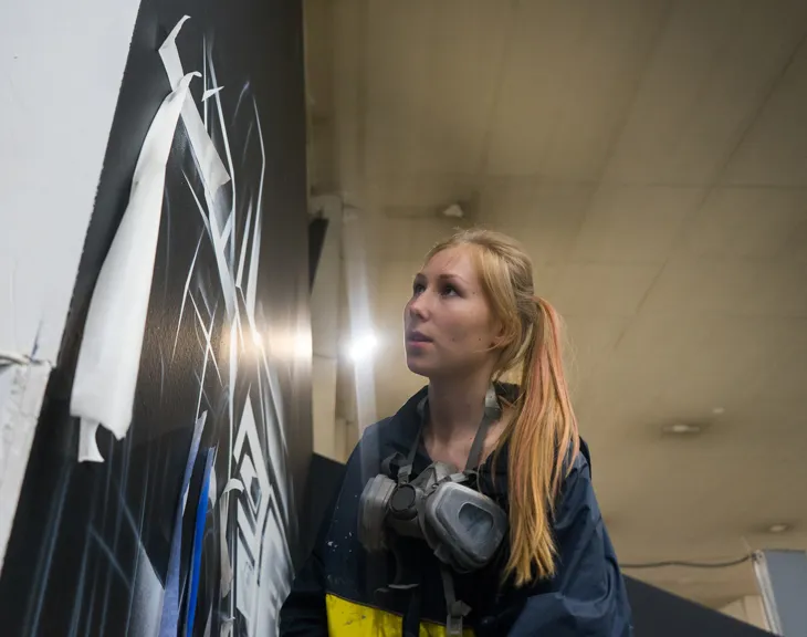 Kseniia Derr in the studio with her paintings and tufted rugs., 13 / 22