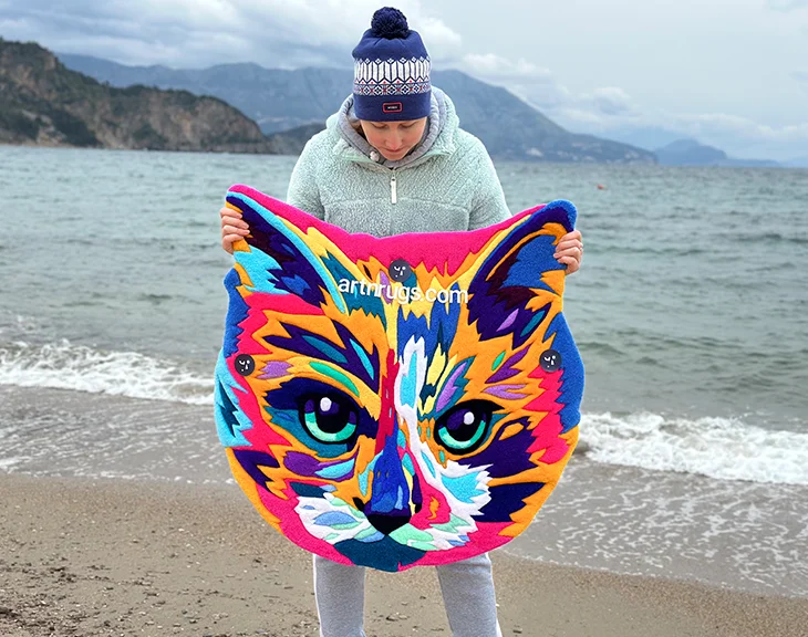 Kumda kedi yüzlü parlak, çok renkli halının açılı görünümü